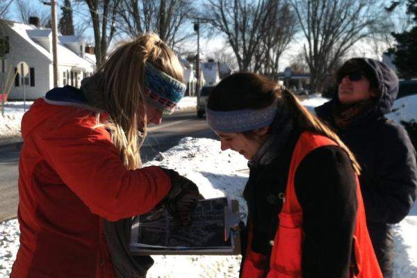 Two people looking at a map of street trees