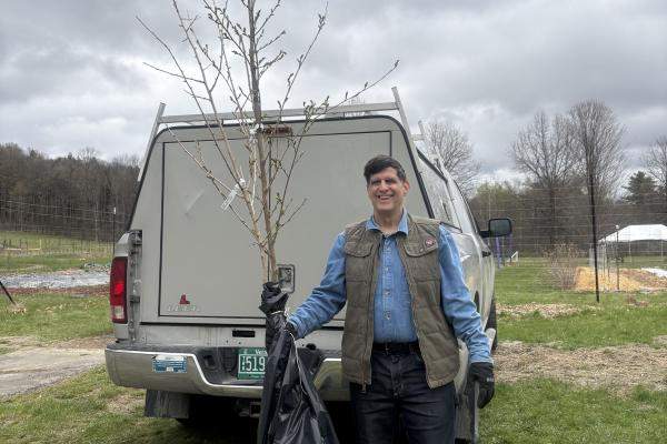 Williamstown Tree Warden stands in front of his truck with a UCF Nursery Tree