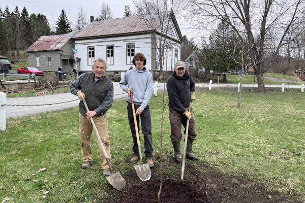 Dominick Hale planting a tree in Cabot