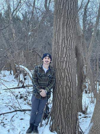 Max Hertz standing next to tree