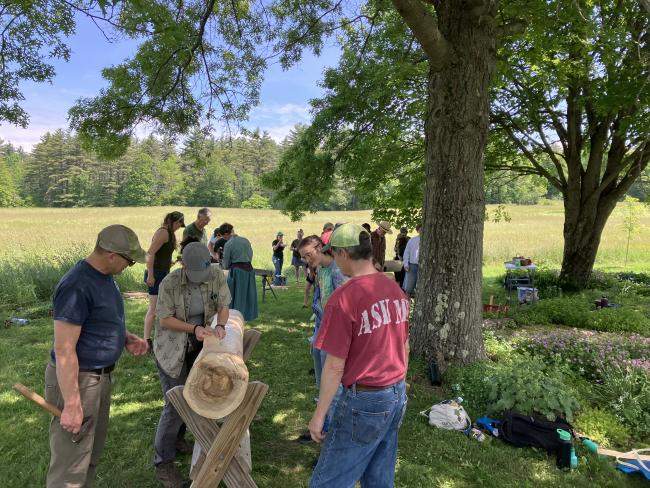 People pounding black ash logs