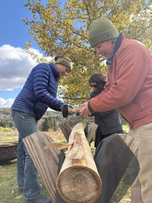 Three people pounds splints from a black ash log.