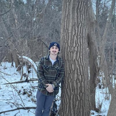 Max Hertz standing next to tree