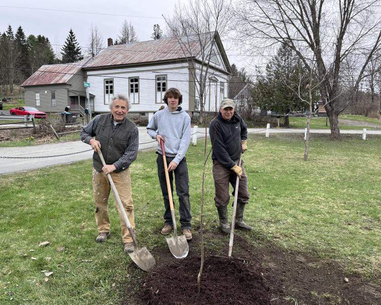 Dominick Hale planting a tree in Cabot